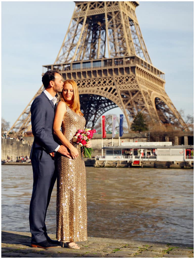 A cute anniversary and baby announcement photo session by the Eiffel Tower in Paris, France
